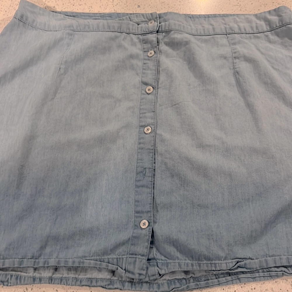 Light blue send denim button down skirt.
